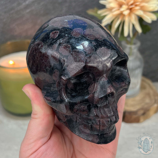 Polished Arfvedsonite and Garnet Firework Skull Carving