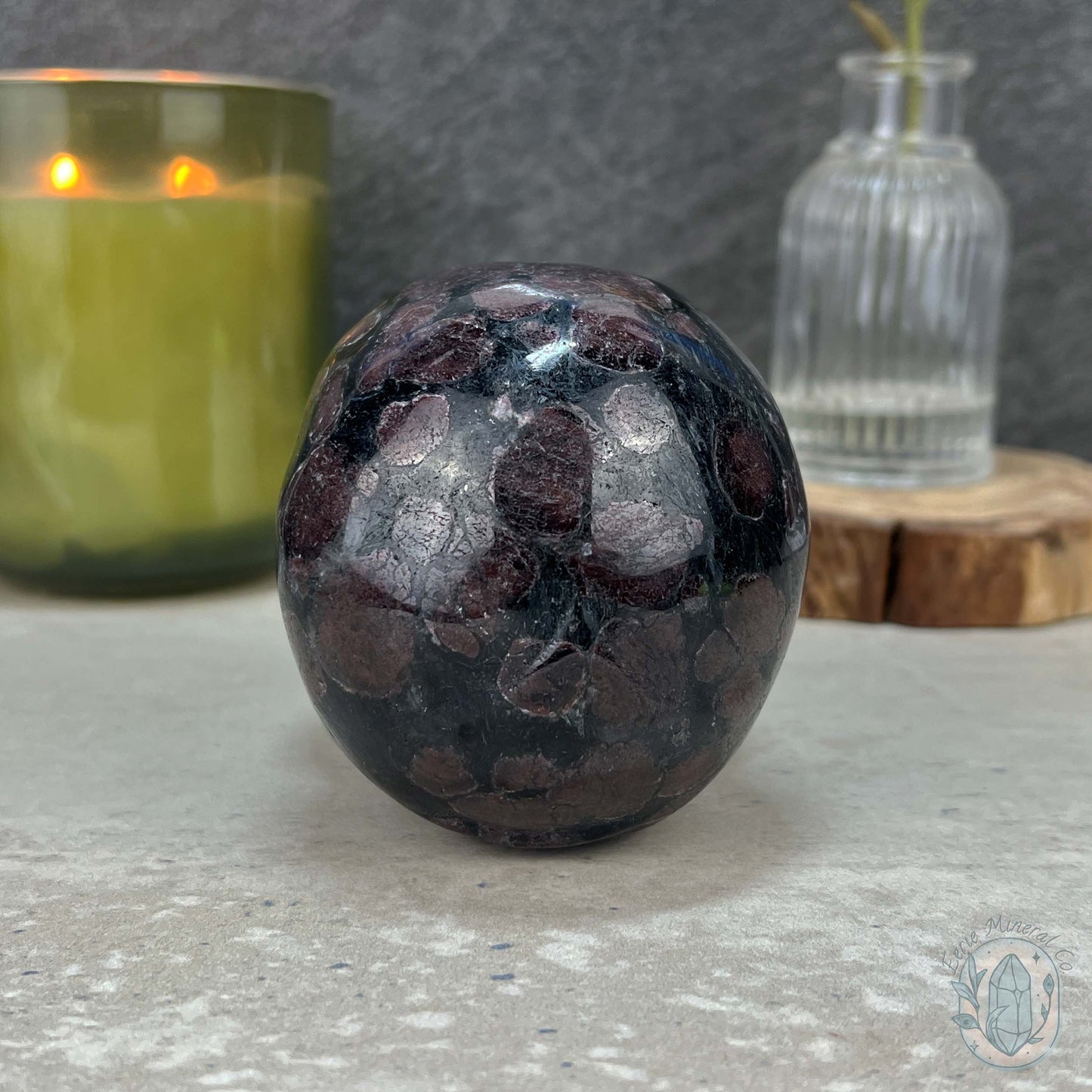 Polished Arfvedsonite and Garnet Firework Skull Carving