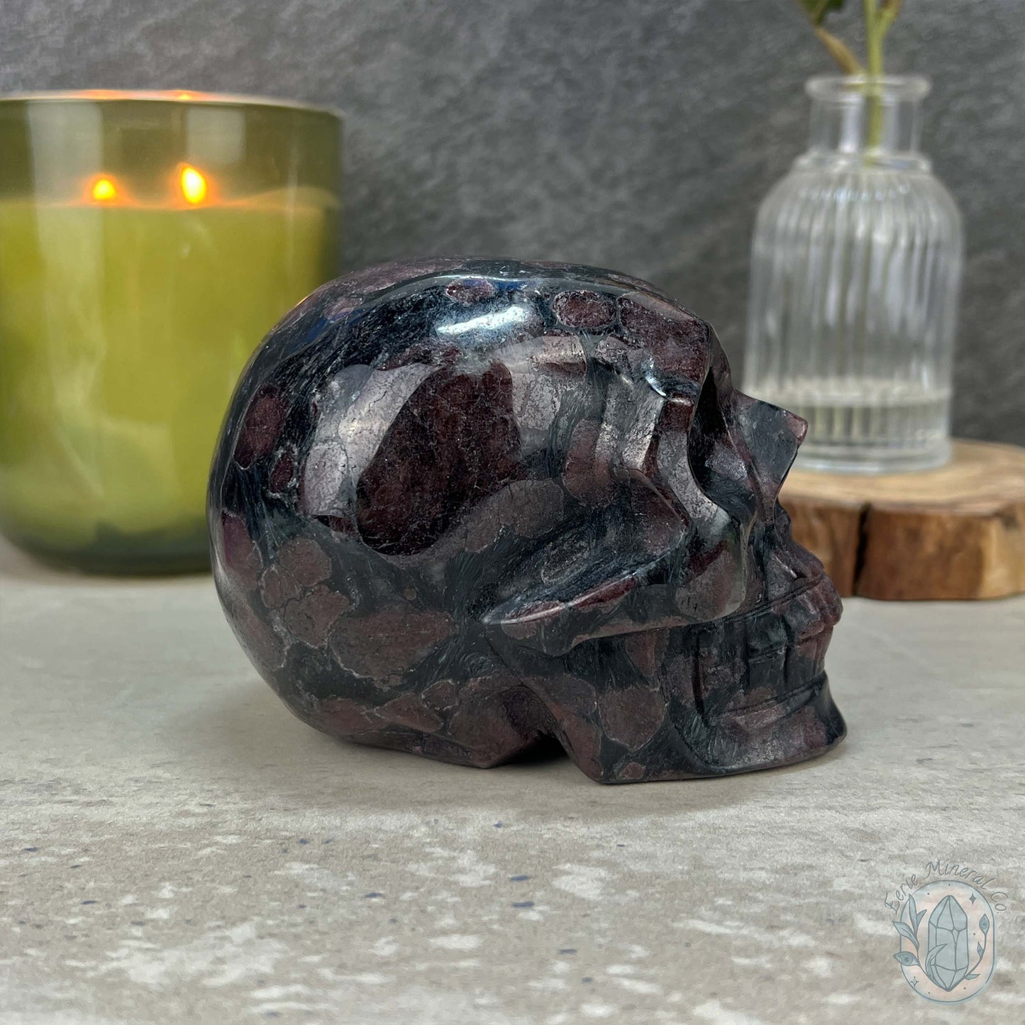 Polished Arfvedsonite and Garnet Firework Skull Carving