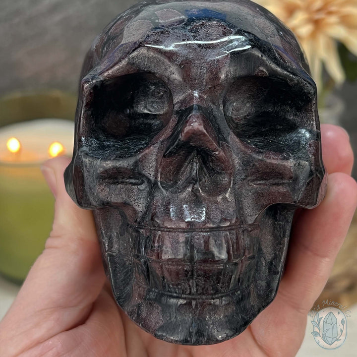 Polished Arfvedsonite and Garnet Firework Skull Carving