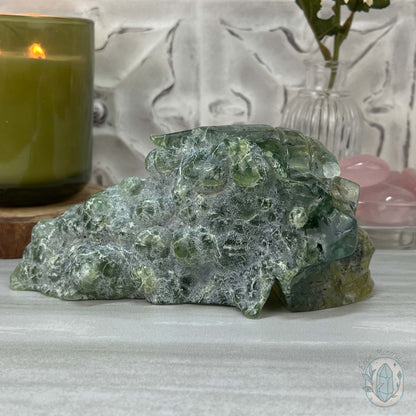 Polished Prehnite Skull with Headdress Carving