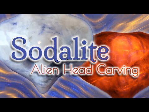 Sodalite Alien head carving on display stand - uv reactive