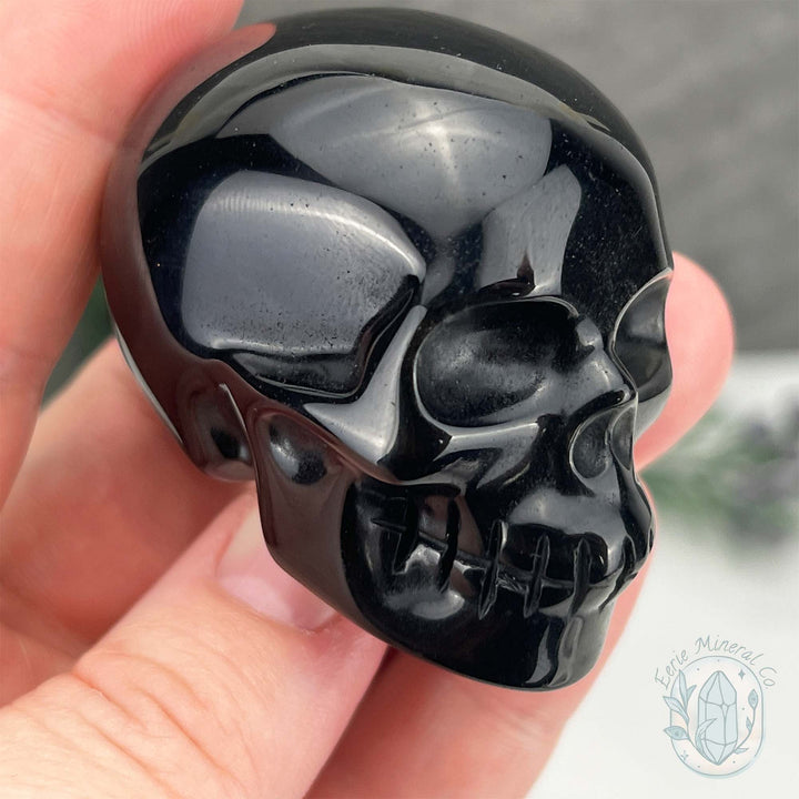 Polished Silver Obsidian Skull Carving