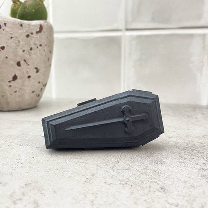 black obsidian coffin carving