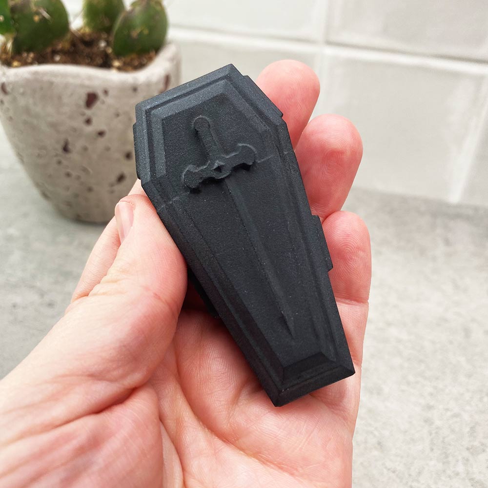 black obsidian coffin carving