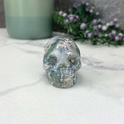 Polished Moss Agate Skull Carving